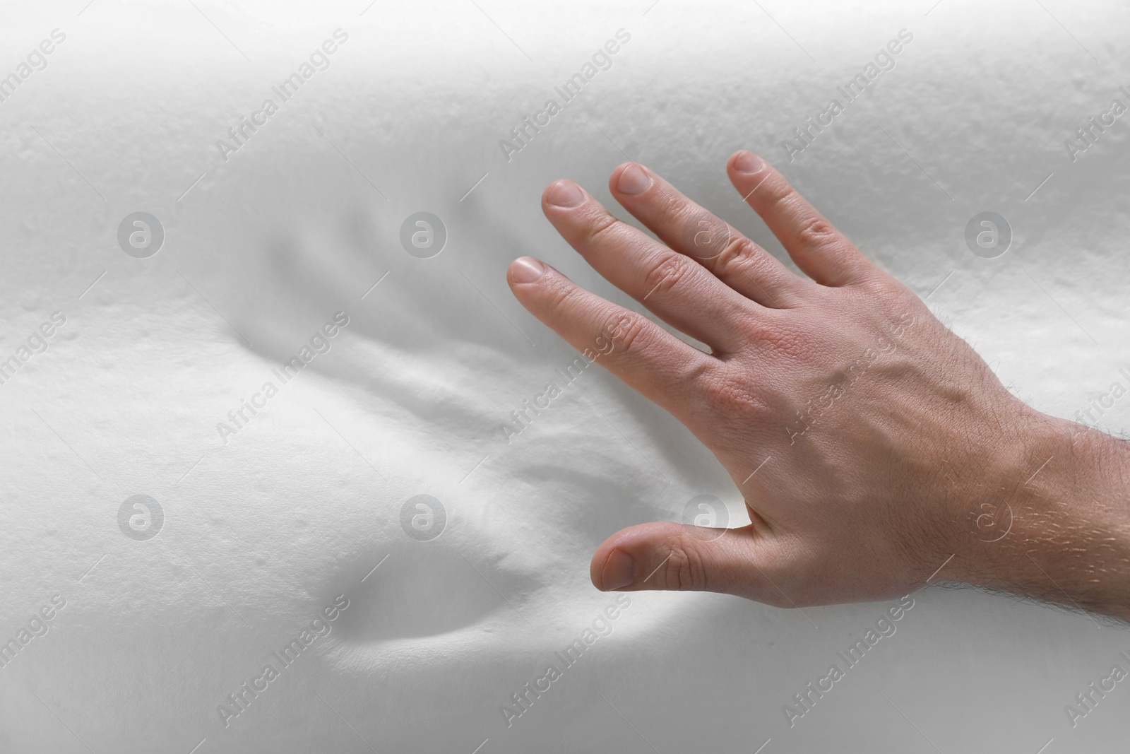 Photo of Man with orthopedic memory foam pillow, above view