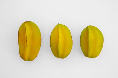 Photo of Delicious ripe carambolas on white background, top view