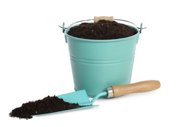 Photo of Bucket and shovel with soil on white background. Gardening tool