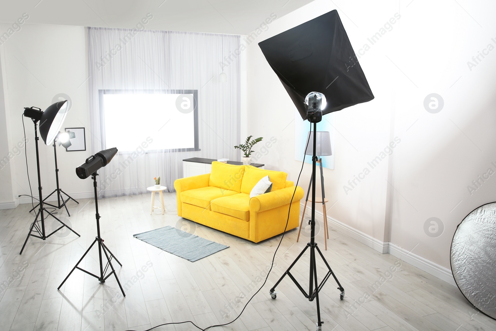 Photo of Example of living room interior design and professional equipment in photo studio