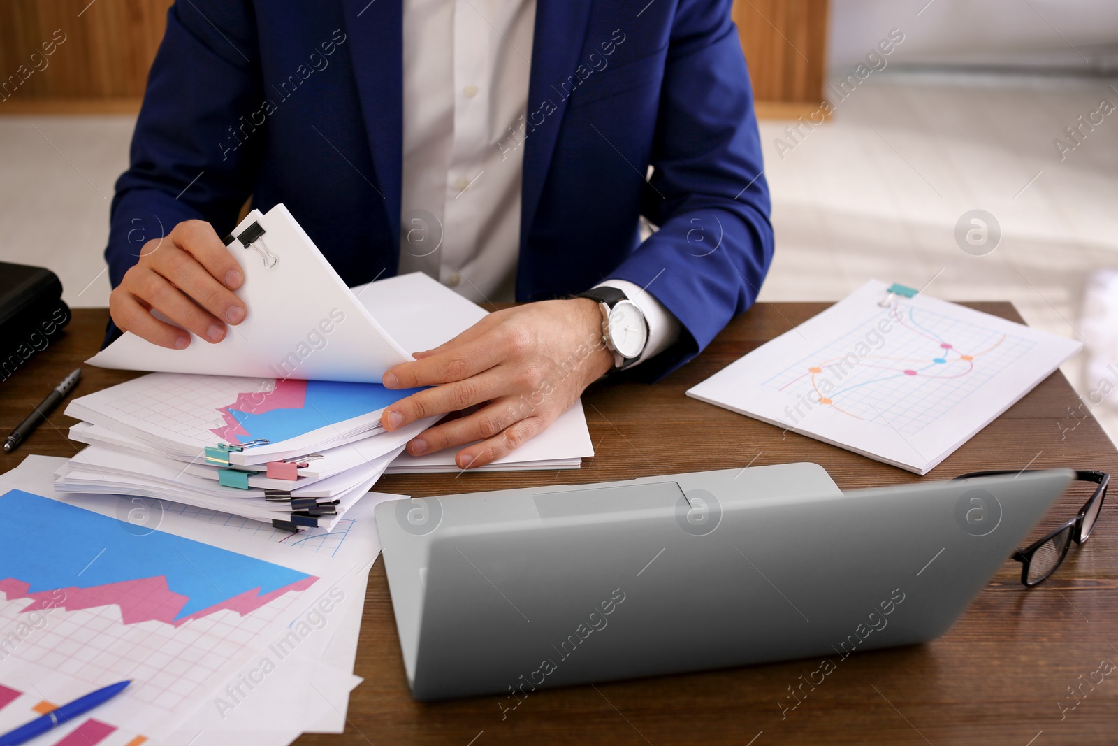 Photo of Businessman working with documents at office table, closeup