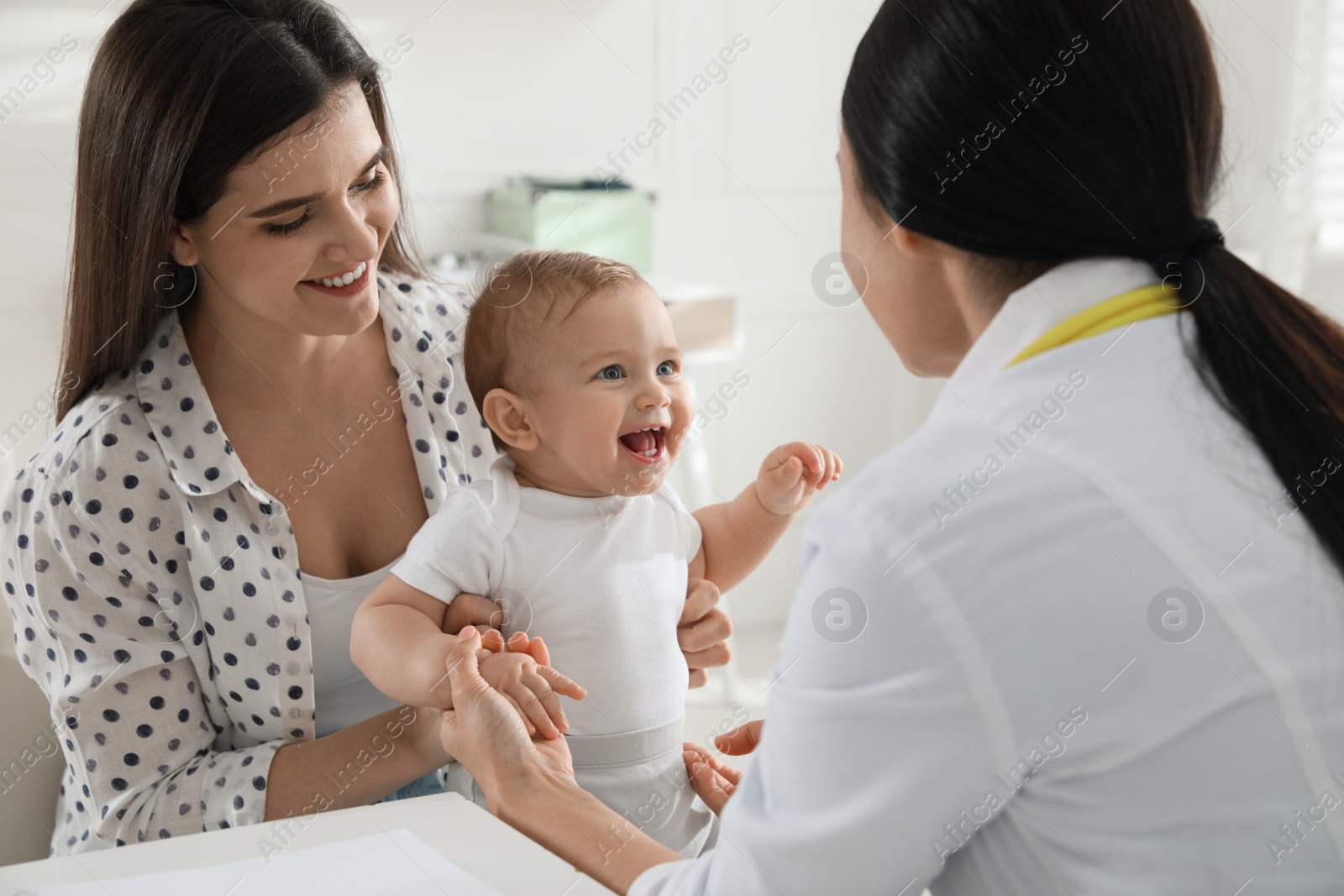 Photo of Mother with her cute baby visiting pediatrician in clinic