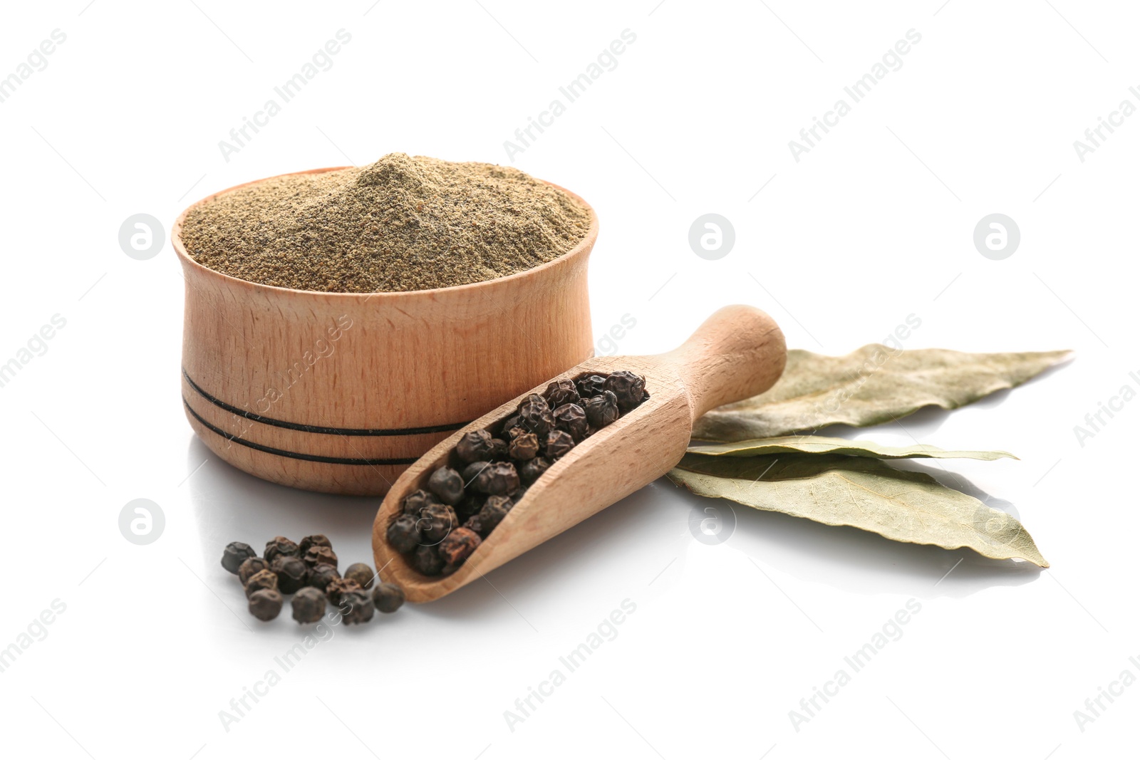 Photo of Bay leaves, scoop with black pepper grains and bowl of powder on white background