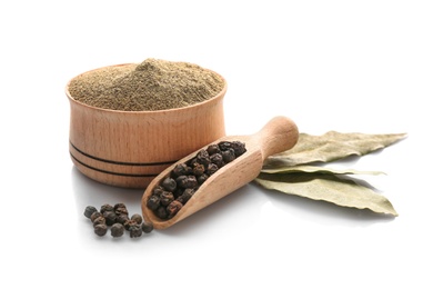 Bay leaves, scoop with black pepper grains and bowl of powder on white background