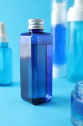 Photo of Different cosmetic products on light blue background