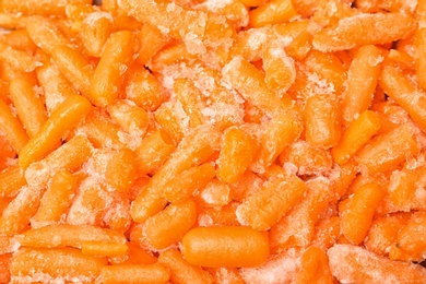 Photo of Frozen carrots as background, top view. Vegetable preservation