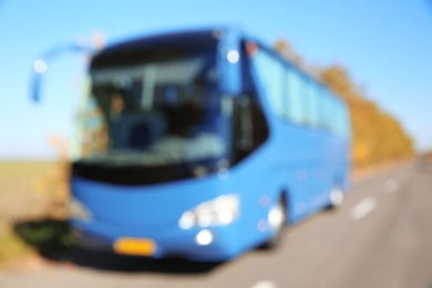 Blurred view of modern blue bus on road. Passenger transportation