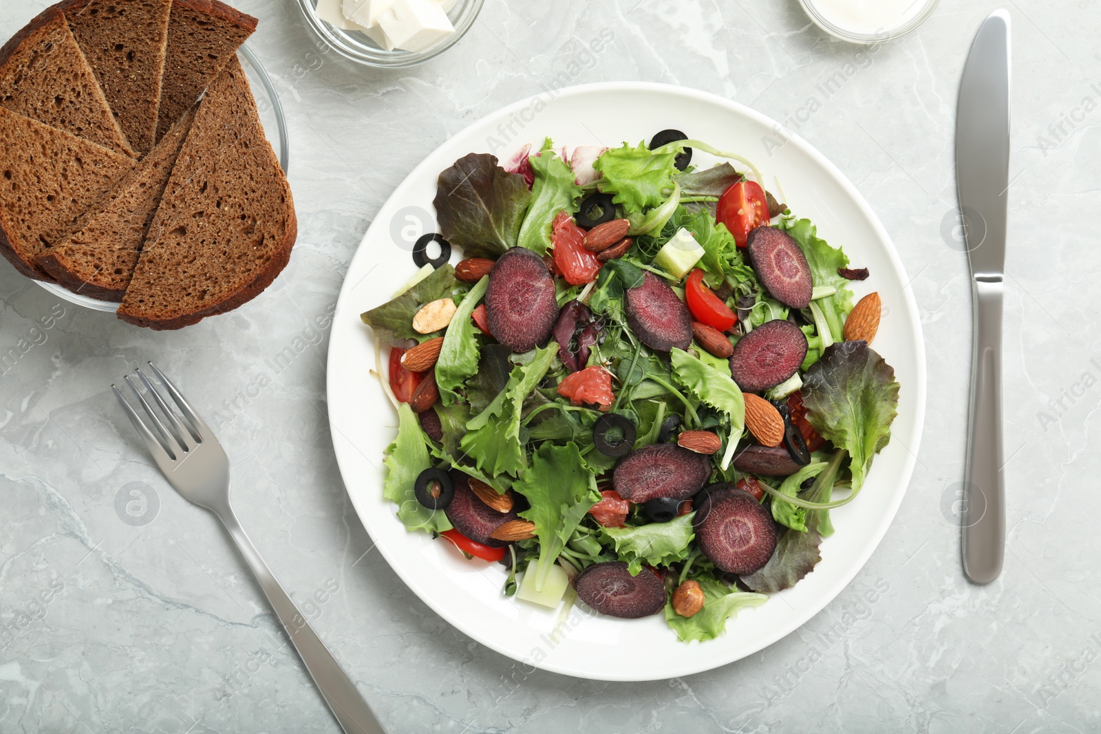 Photo of Delicious carrot salad served on grey table, flat lay