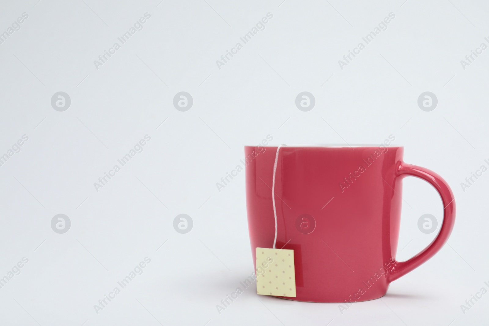 Photo of Cup of tasty tea on white background