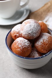 Delicious sweet buns in bowl on gray table, closeup