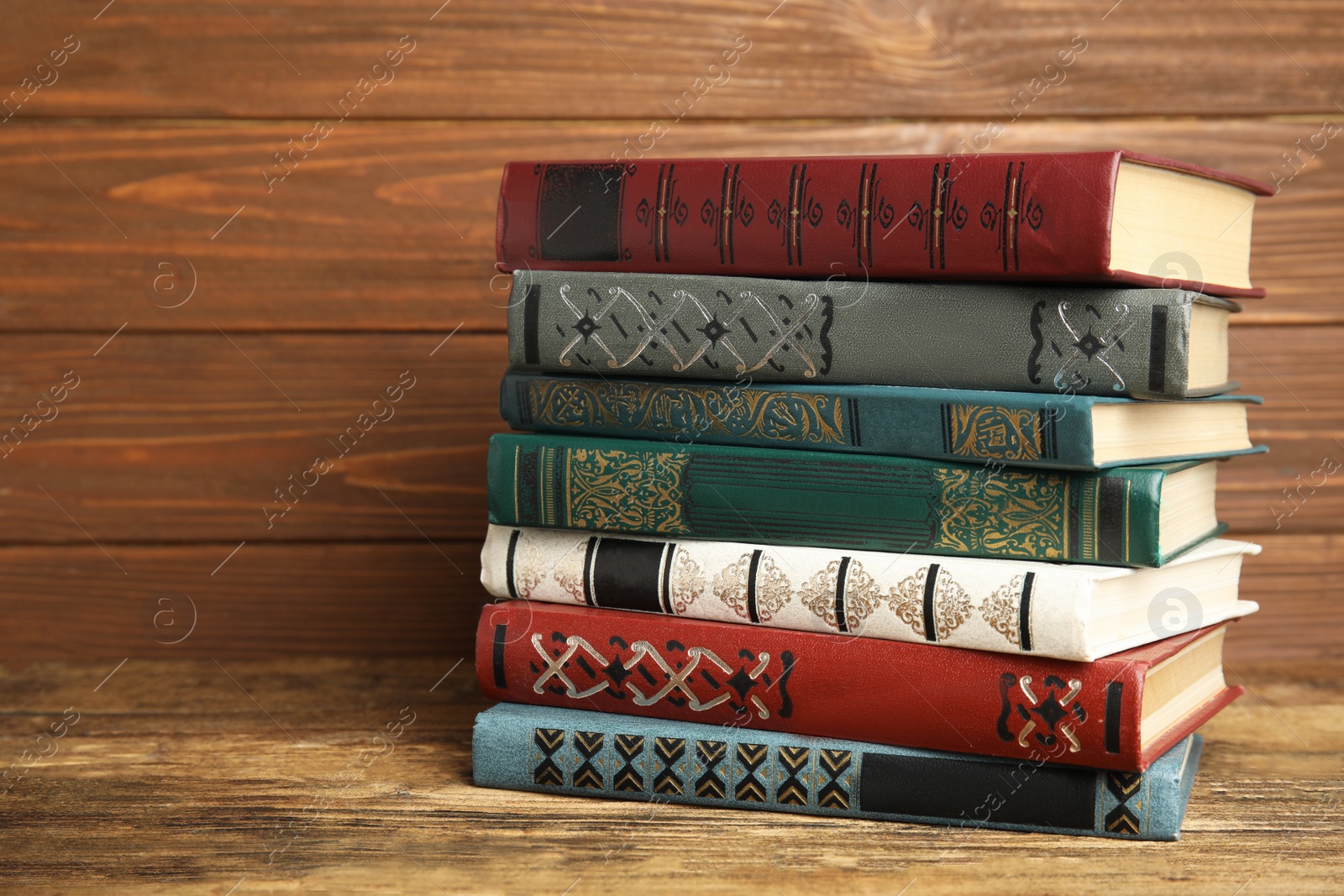 Photo of Collection of old books on wooden shelf