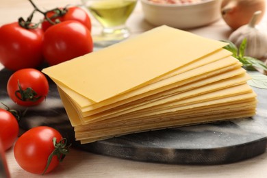 Ingredients for lasagna on white wooden table, closeup