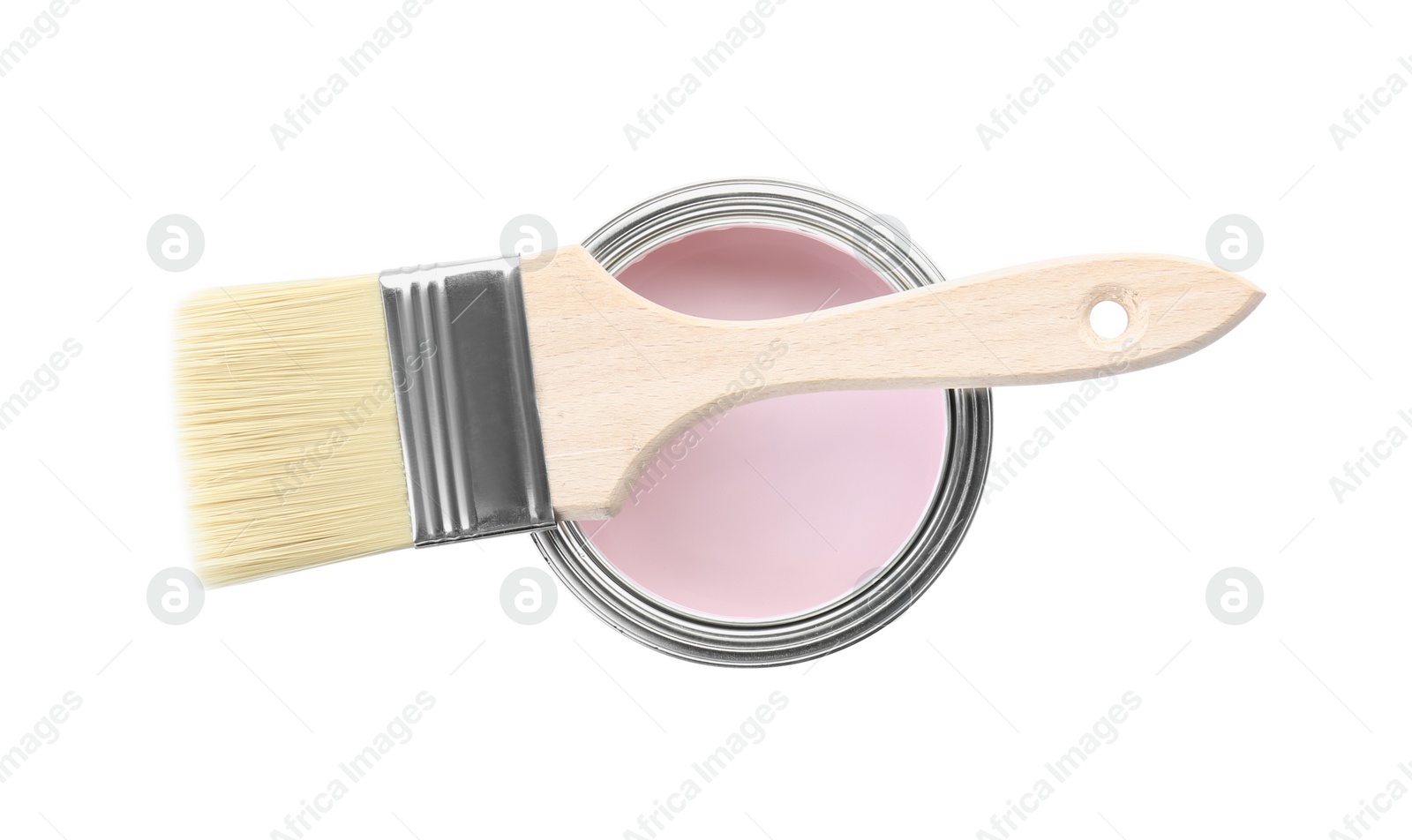 Photo of Can of pale pink paint with brush isolated on white, top view