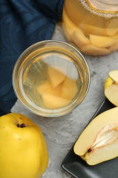 Delicious quince drink and fresh fruits on grey table, flat lay