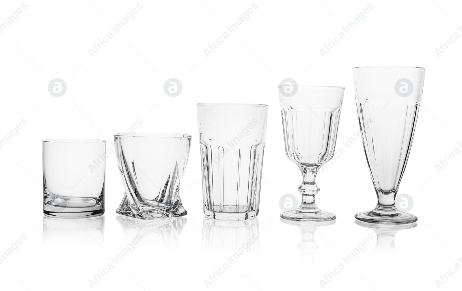 Photo of Set of empty glasses for different drinks on white background