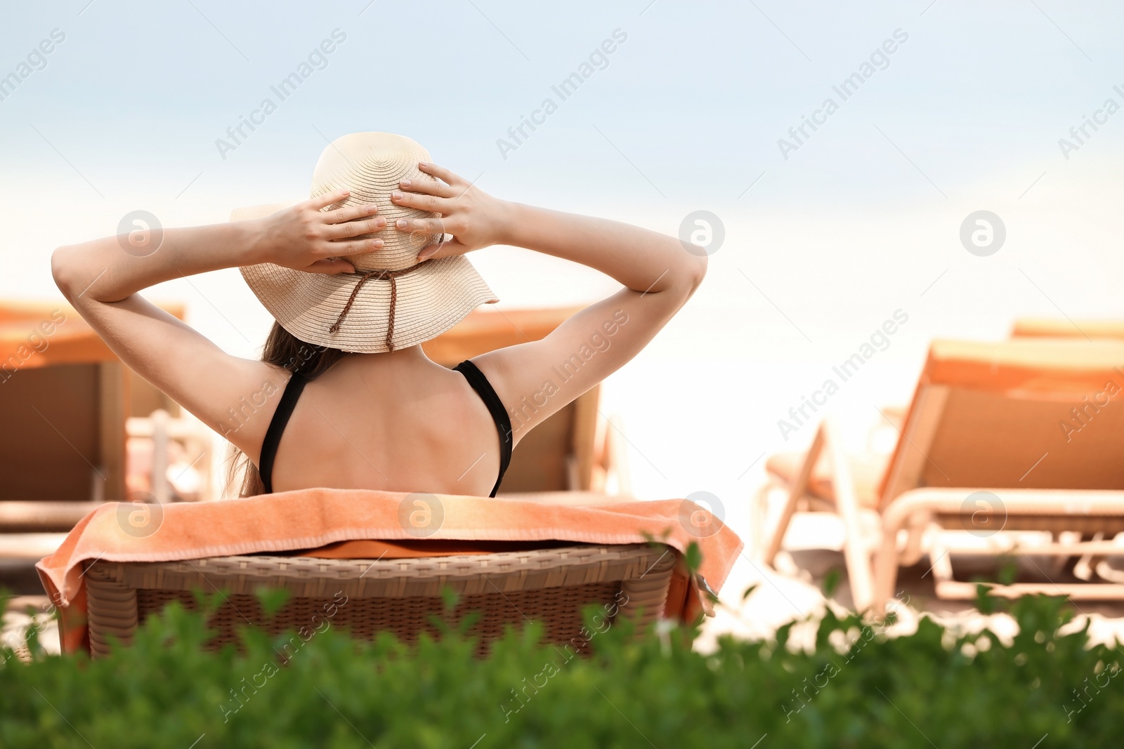 Photo of Beautiful young woman in swimsuit at resort