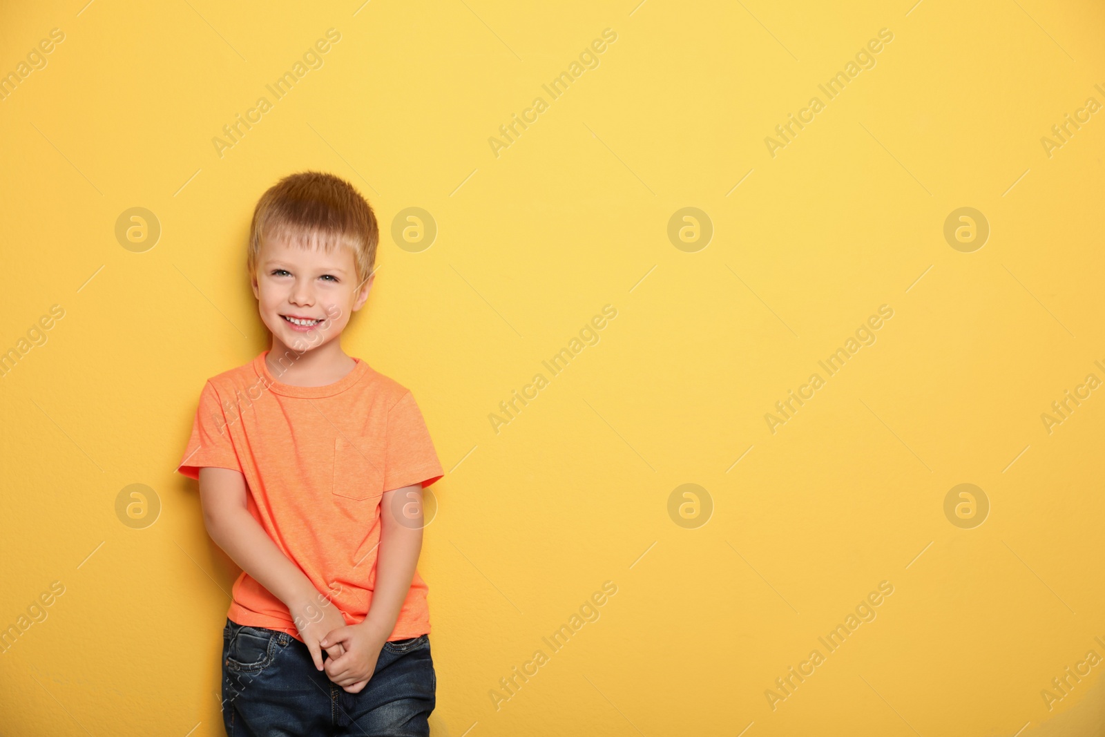 Photo of Portrait of cute little boy against color background with space for text