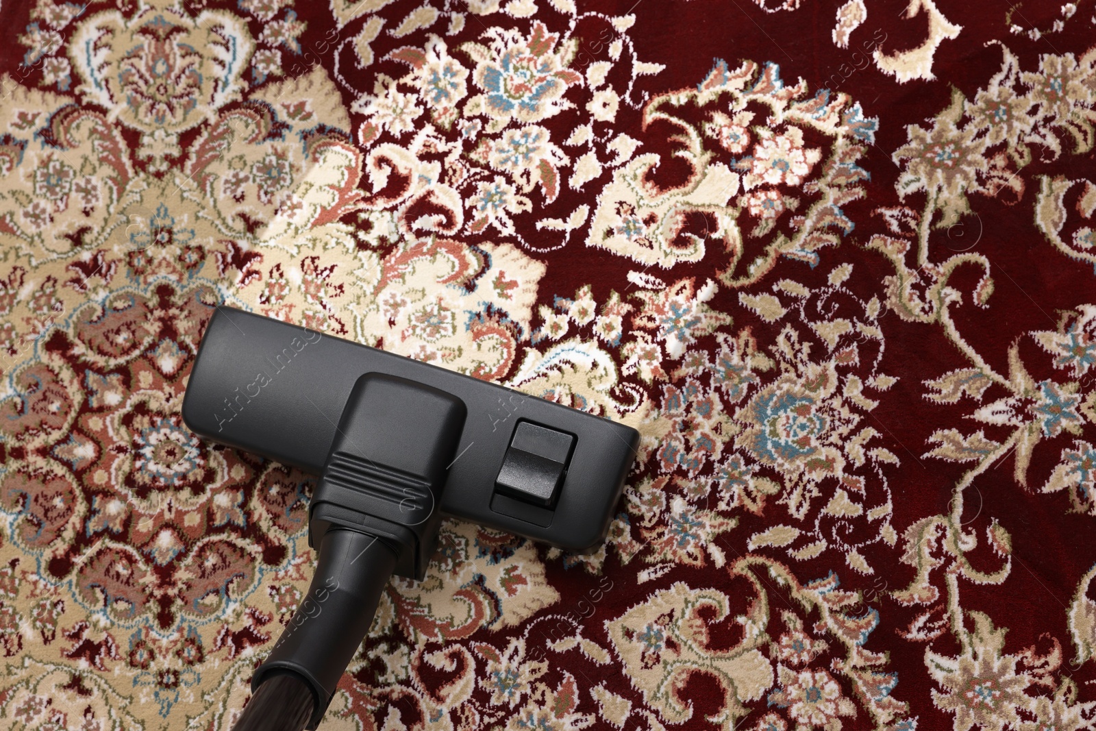 Image of Hoovering carpet with vacuum cleaner, above view and space for text. Clean trace on dirty surface