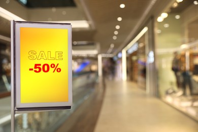 Image of Advertising board with text SALE and 50 percent discount in shopping mall. Special promotion