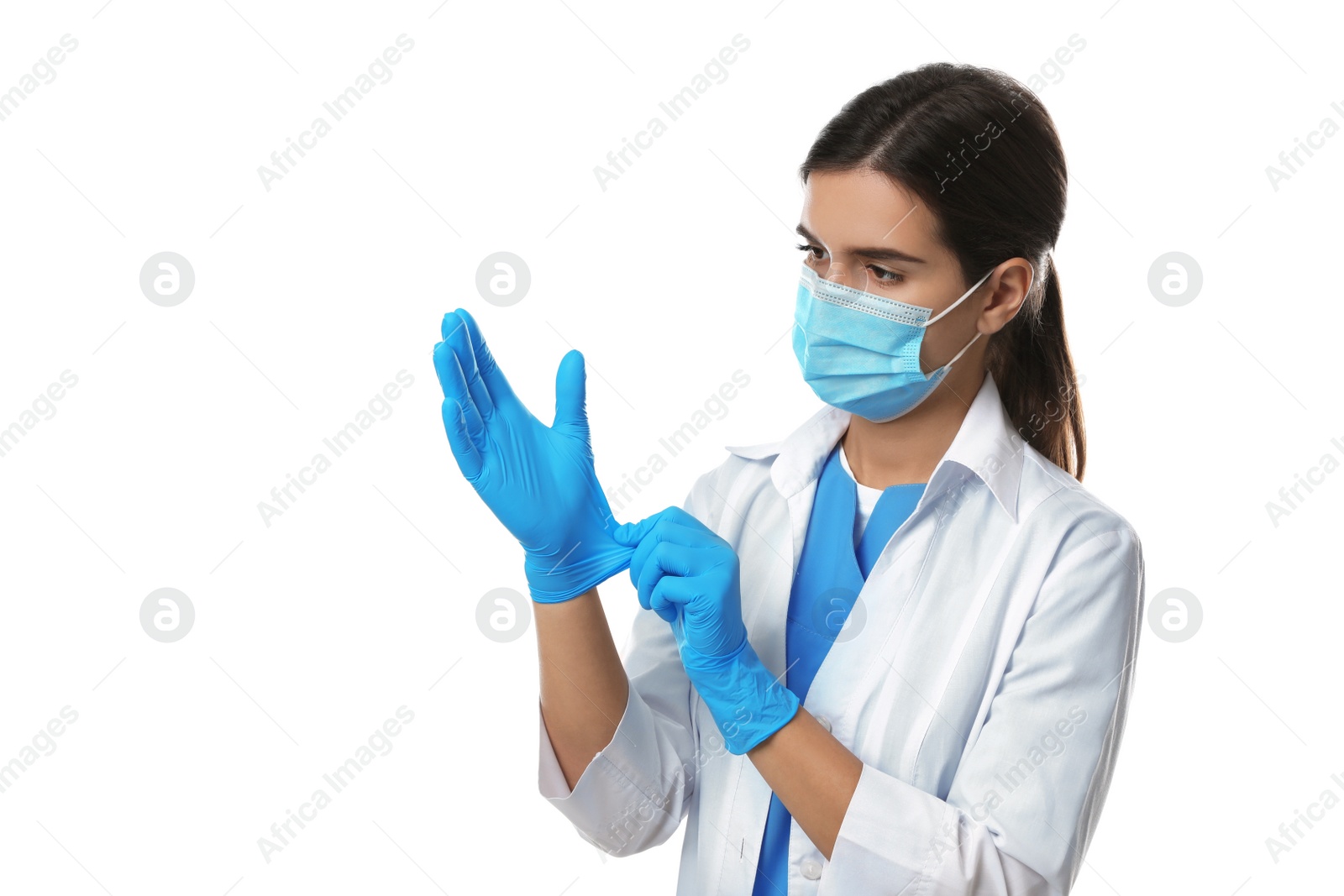 Photo of Doctor in protective mask putting on medical gloves against white background