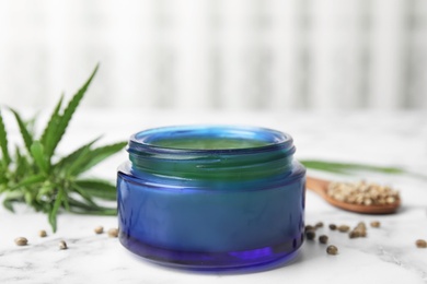 Photo of Jar of hemp cream on marble table. Organic cosmetics