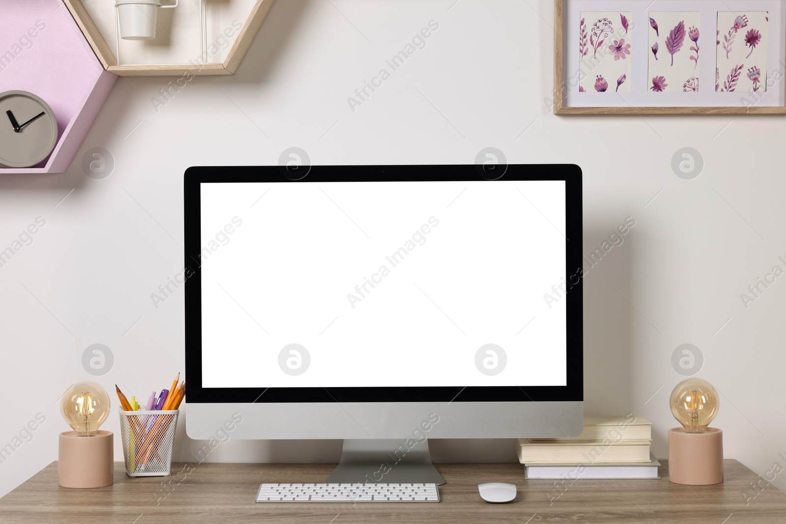 Photo of Cozy workspace with modern computer and stationery on wooden desk