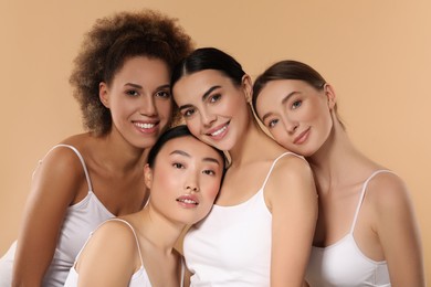 Photo of Beautiful young women with healthy skin on beige background