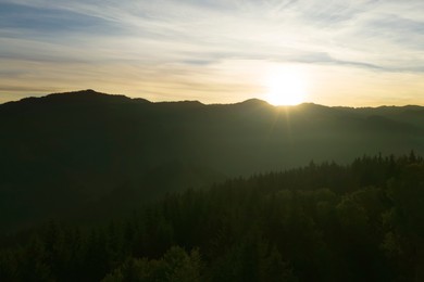 Image of Aerial view of beautiful mountain landscape with green trees at sunrise