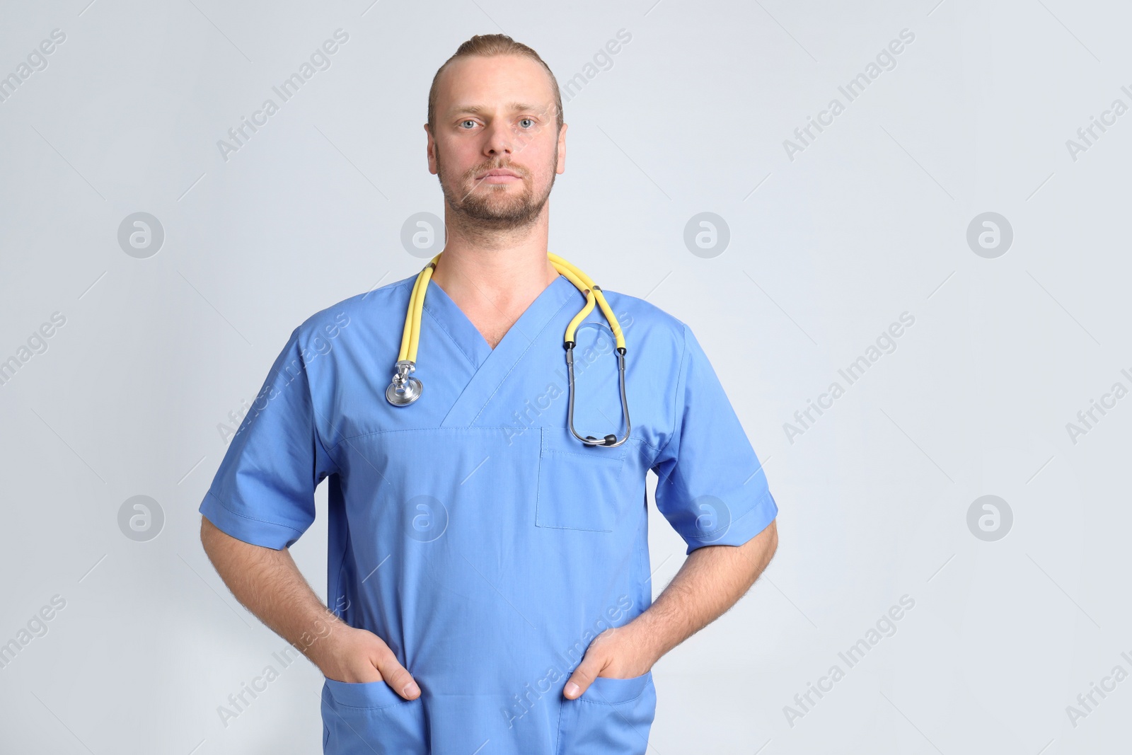 Photo of Portrait of medical assistant with stethoscope on color background. Space for text