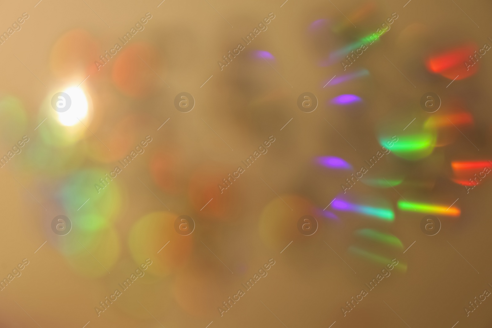 Photo of Blurred view of shiny lights on beige background. Bokeh effect