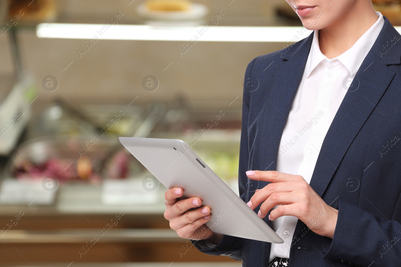 Image of Inspector with tablet in canteen, closeup. Quality control