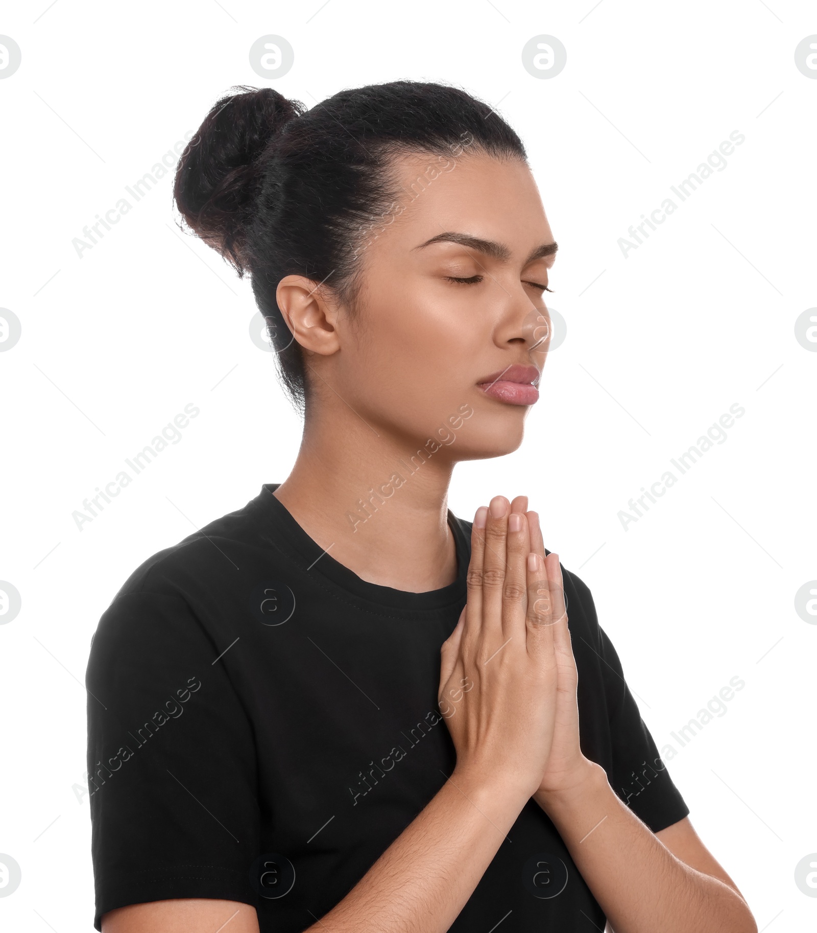 Photo of African American woman with clasped hands praying to God on white background