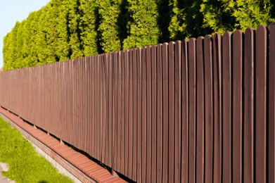 Photo of Beautiful wooden fence on sunny day outdoors