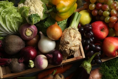 Different fresh vegetables in wooden crates as background, top view. Farmer harvesting