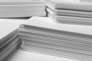 Photo of Stacks of paper sheets as background, closeup