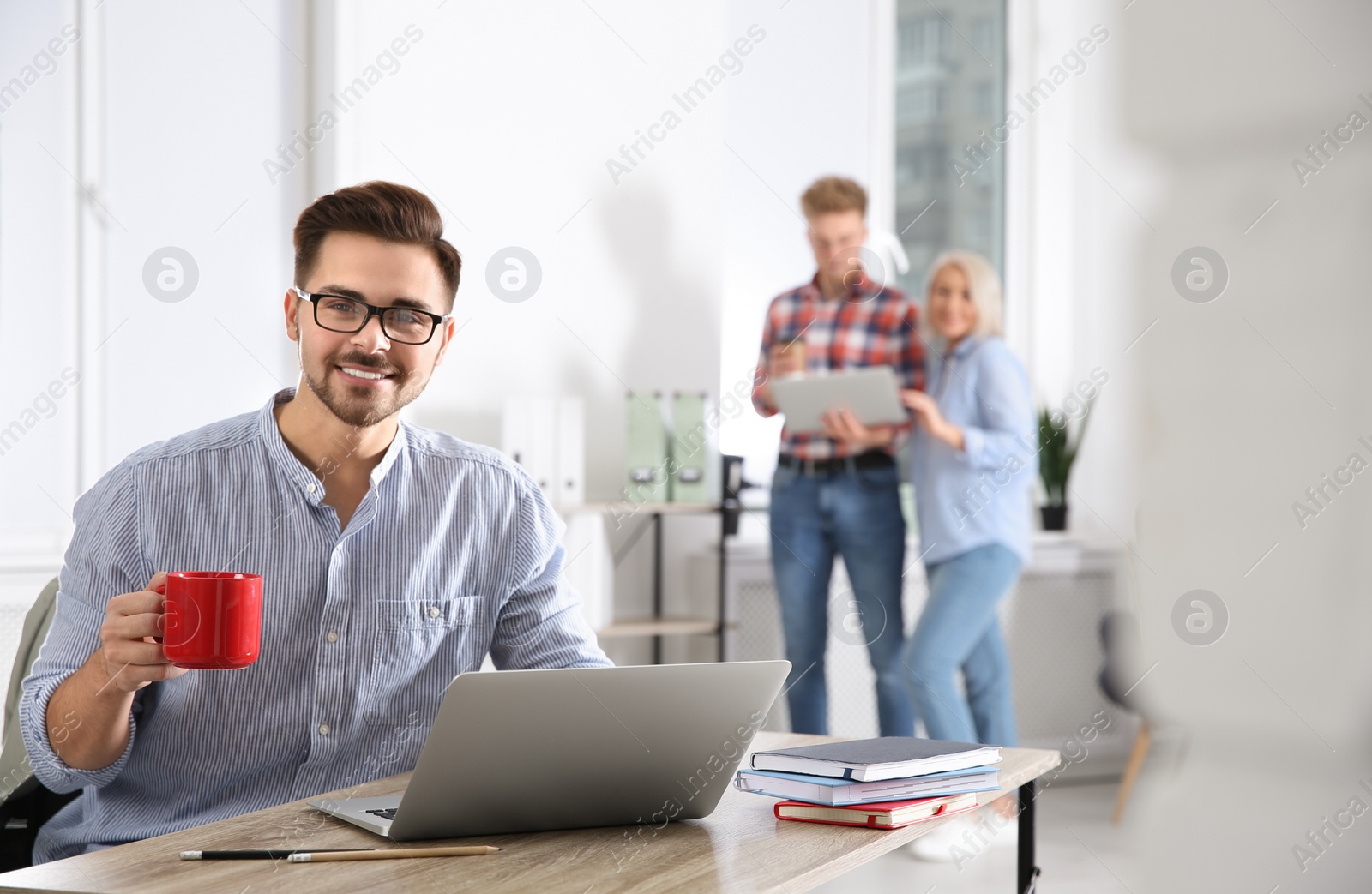 Photo of Businessman with colleagues working in office, space for text. Professional communication