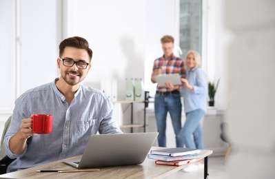 Photo of Businessman with colleagues working in office, space for text. Professional communication