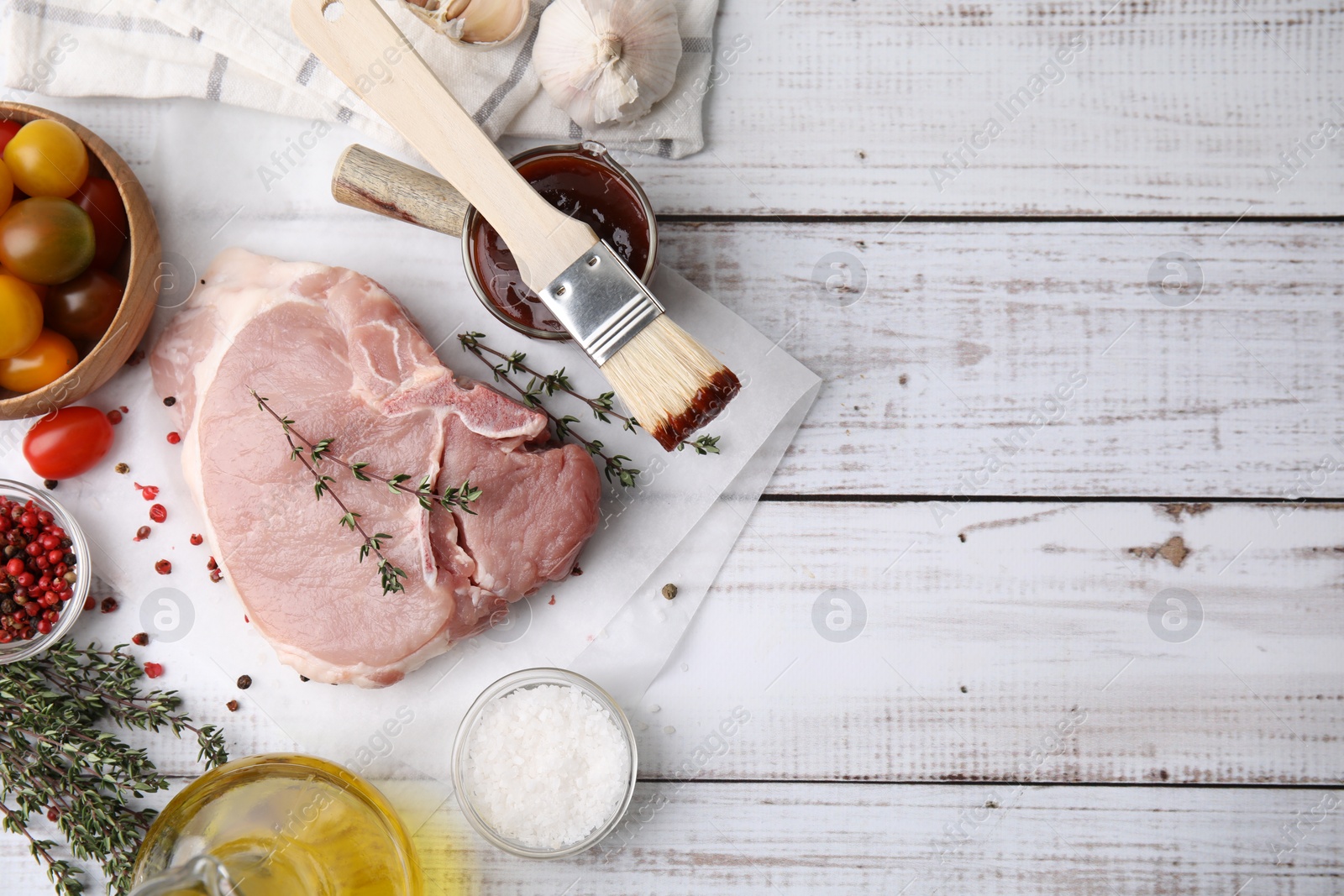 Photo of Flat lay composition with raw meat, thyme and marinade on rustic wooden table. Space for text