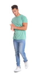 Young man in stylish jeans on white background