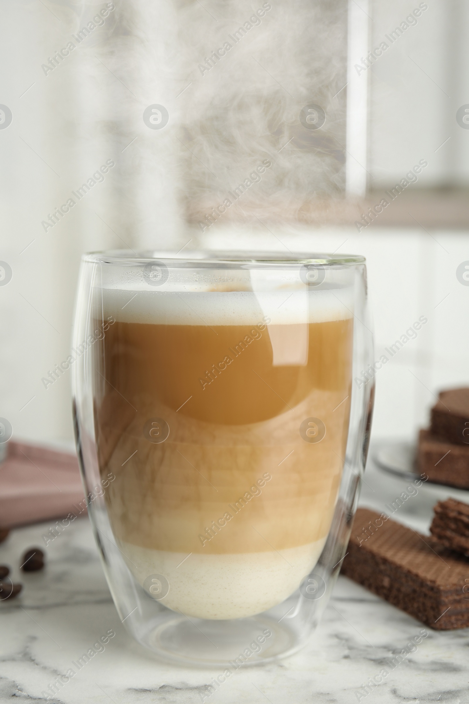 Photo of Delicious coffee and wafers for breakfast on white marble table