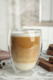 Photo of Delicious coffee and wafers for breakfast on white marble table