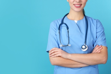 Photo of Young medical student in uniform on color background, closeup. Space for text
