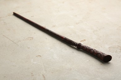 Photo of One magic wand on light textured background, closeup