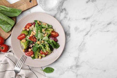 Photo of Healthy meal. Tasty salad with quinoa, chickpeas and vegetables served on white marble table, flat lay with space for text