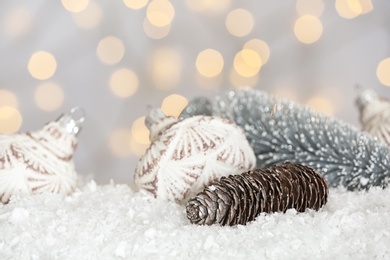 Photo of Christmas decoration on snow against blurred background