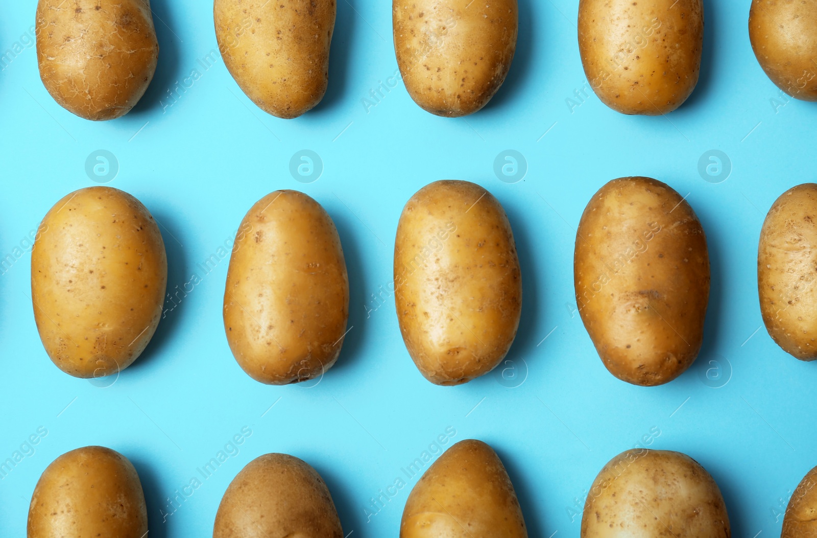 Photo of Flat lay composition with fresh ripe organic potatoes on color background