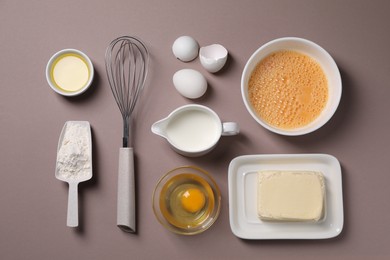 Photo of Flat lay composition with whisk and dough ingredients on grey background