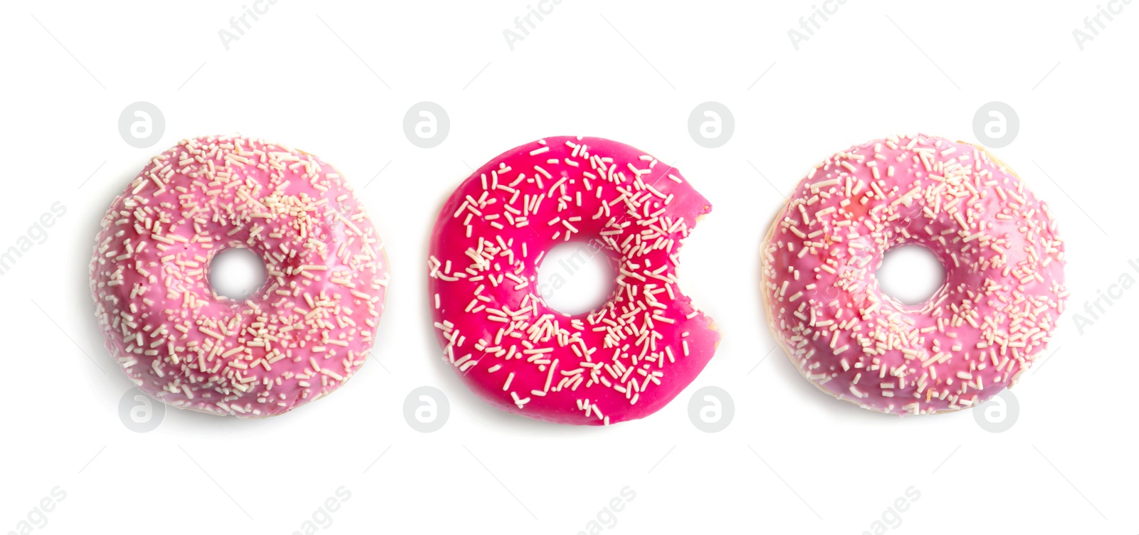 Photo of Delicious doughnuts with sprinkles on light background, top view