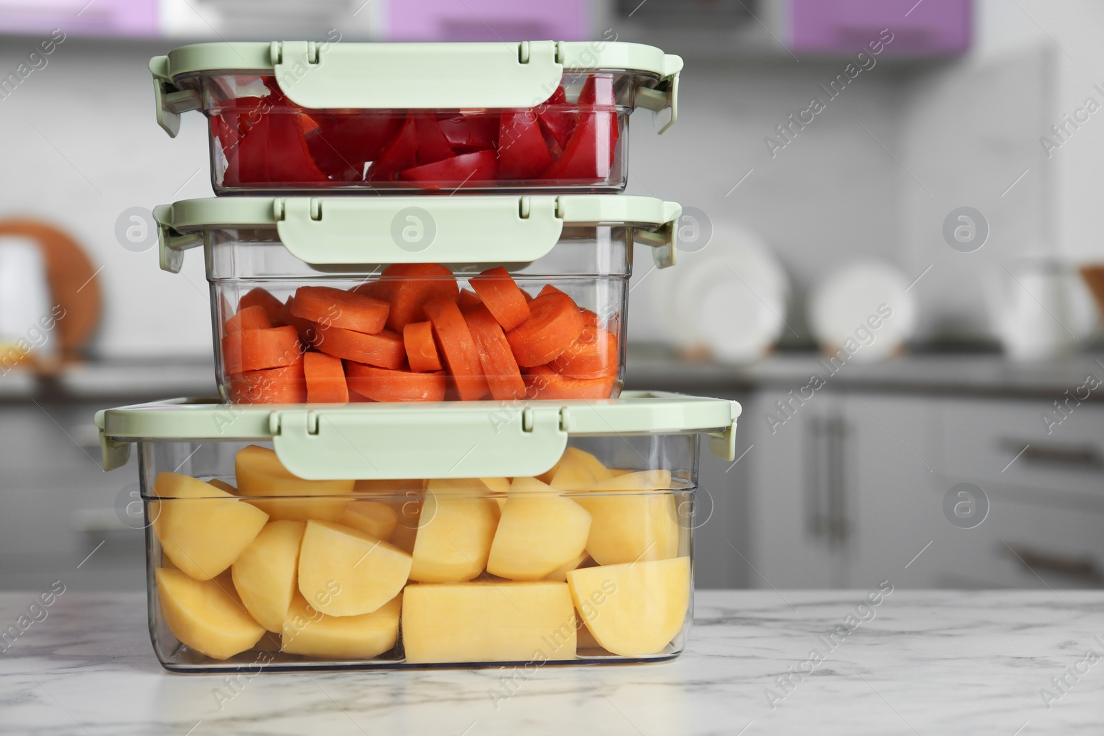 Photo of Boxes with fresh raw vegetables on table in kitchen, space for text