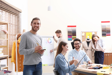 Photo of Fashion designers creating new clothes in studio